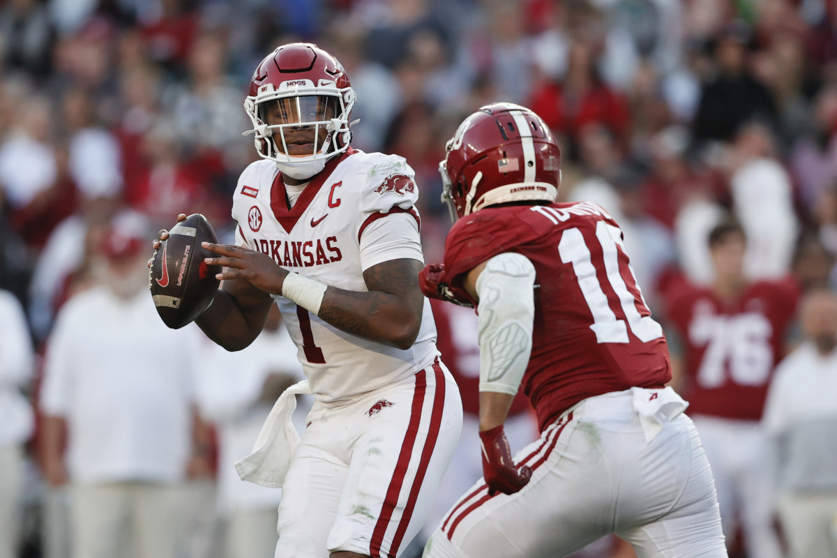 Arkansas Razorbacks quarterback KJ Jefferson (1) rolls out to pass as Alabama Crimson Tide linebacker Henry To'oTo'o (10) applies pressure during the first half at Bryant-Denny Stadium.